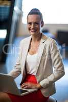 Beautiful businesswoman holding laptop