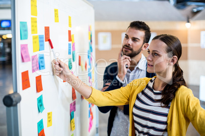 Colleagues looking at white board