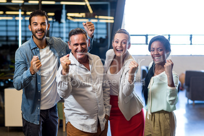 Business colleagues cheering with clenched fist