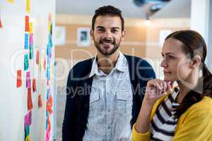 Colleagues looking at white board