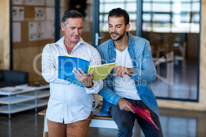 Colleagues looking at file