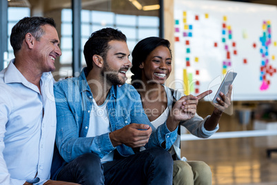 Happy Colleagues using mobile phone