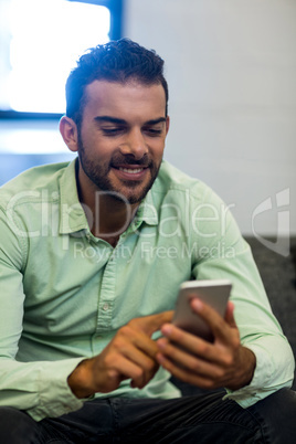 Young man text messaging on mobile phone