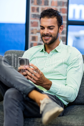 Young man text messaging on mobile phone