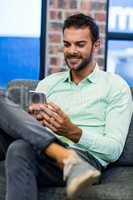 Young man text messaging on mobile phone