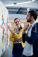 Colleagues looking at white board