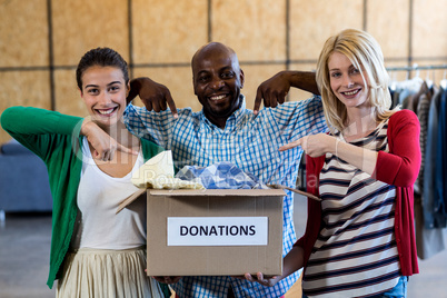 Colleagues holding donation box