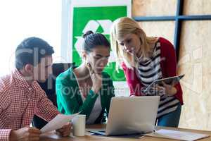 Colleague discussing with at desk