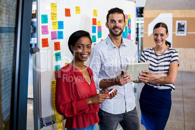 Colleagues standing in front of the white board