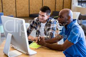 Colleagues working on computer