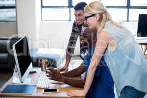 Colleagues working on computer together