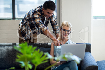 Colleagues interact using laptop