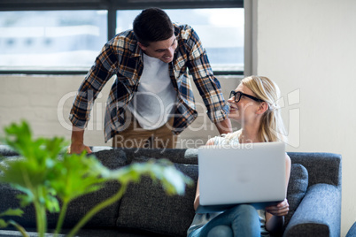 Colleagues interact using laptop