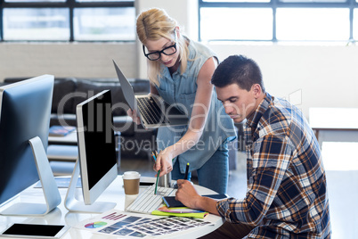 Graphic designer interacting at their desk