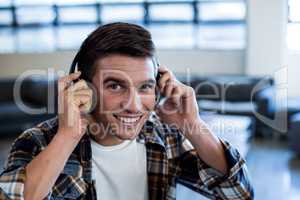 Young man listening to music with headphone