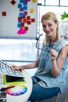 Graphic designer sitting at her desk in the office