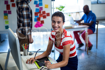 Graphic designer sitting at her desk in the office