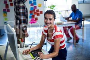 Graphic designer sitting at her desk in the office