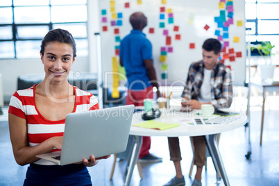 Young woman holding laptop