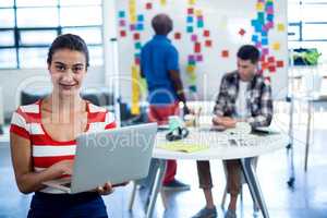 Young woman holding laptop