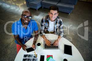 Colleagues using digital tablet and laptop