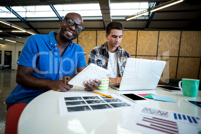 Colleagues using digital tablet and laptop