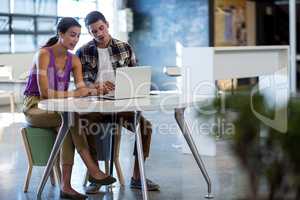 Colleagues working together at their desk