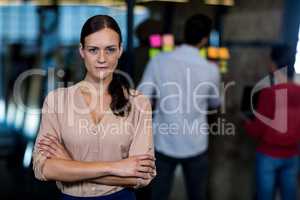 Young woman with arms crossed looking at camera