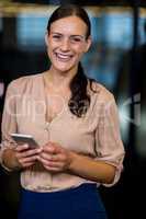 Young woman text messaging on mobile phone