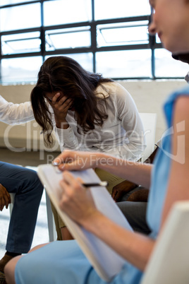 Colleagues comforting a unhappy woman Colleagues comforting a unhappy woman