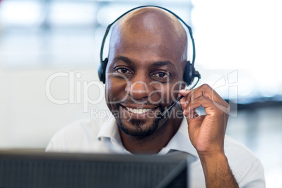 Man working on computer with headset