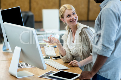 Colleagues working on computer together