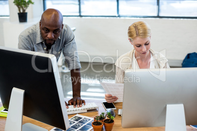 Colleagues working on computer together