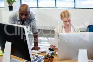 Colleagues working on computer together