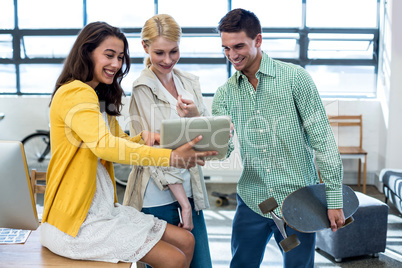 Team of colleagues using digital tablet