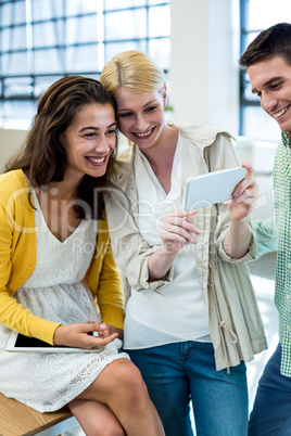 Colleagues using mobile phone