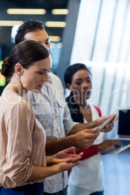 Colleagues discussing using digital tablet