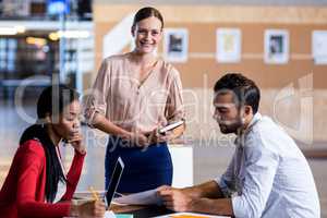 Team of colleagues writing notes at their desk