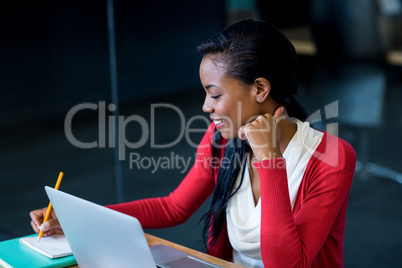 Young woman sitting at her desk