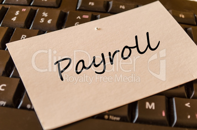 Payroll - note on keyboard in the office