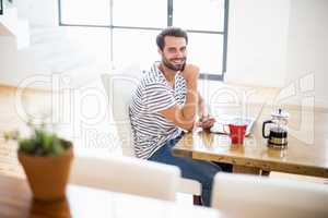 A Man is sitting at desk in front of his laptop