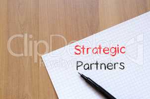 Strategic partners write on notebook