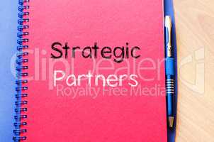 Strategic partners write on notebook