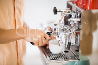 Man preparing coffee from coffeemaker