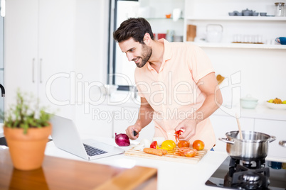 Man looking recipe on laptop