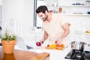 Man looking recipe on laptop