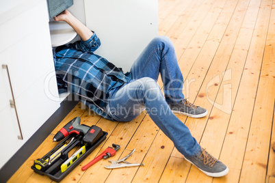 Man fixing kitchen sink