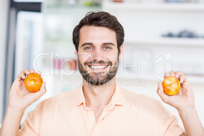 A Man is holding tomatoes