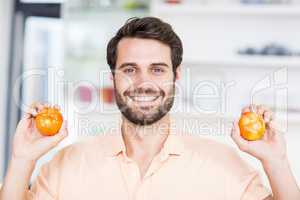 A Man is holding tomatoes