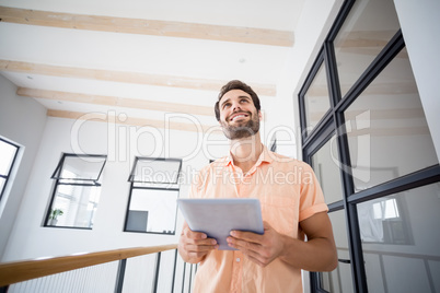 Man holding digital tablet at home Man holding digital tablet at home